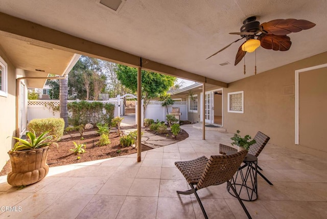 view of patio with a ceiling fan and fence