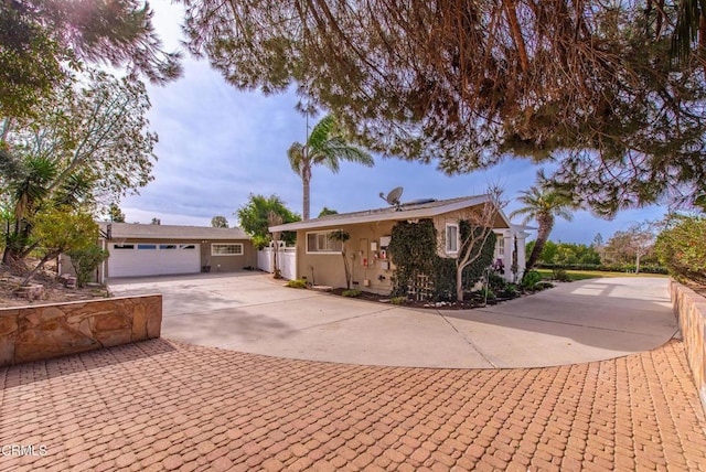 single story home with stucco siding, concrete driveway, and an attached garage