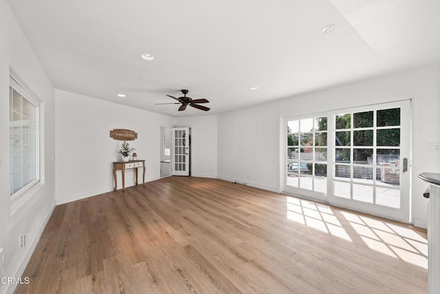 unfurnished living room with recessed lighting, a ceiling fan, light wood-type flooring, and baseboards