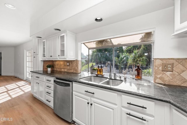 kitchen featuring a sink, plenty of natural light, stainless steel dishwasher, and light wood finished floors