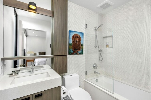 full bathroom featuring vanity, toilet, and tiled shower / bath combo