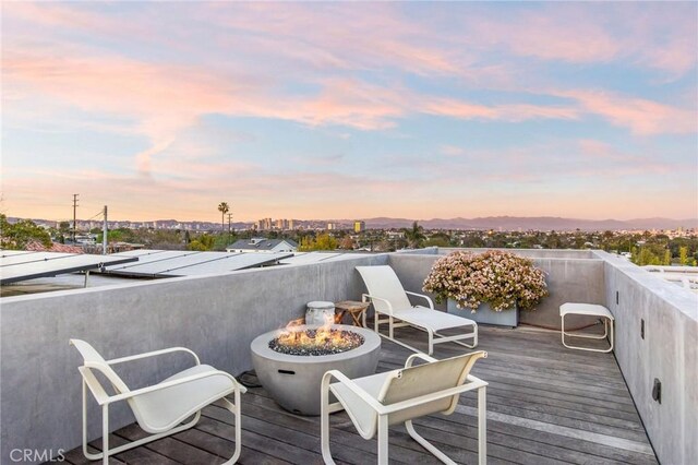 deck at dusk with a fire pit