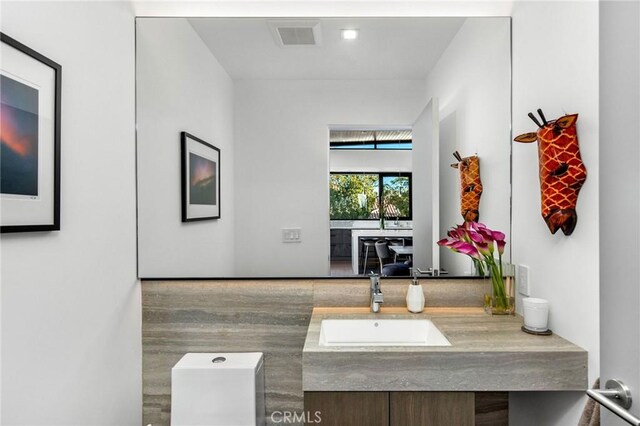 interior space with vanity and toilet