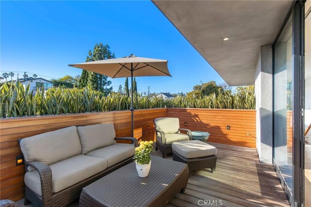 wooden deck with an outdoor living space