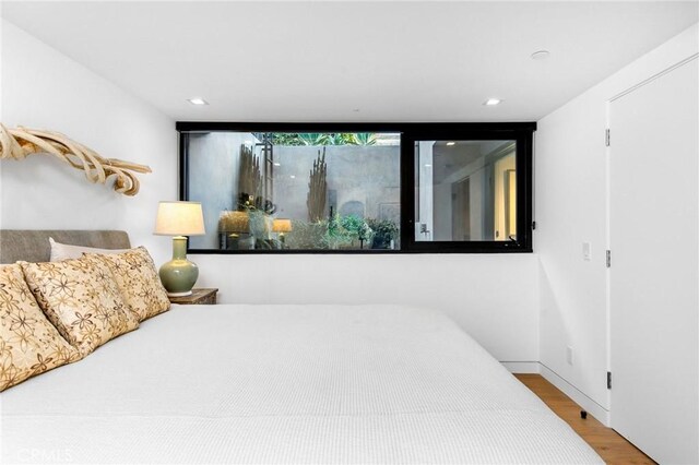 bedroom with wood-type flooring