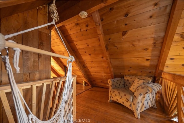 living area featuring vaulted ceiling with beams, wood ceiling, wooden walls, and hardwood / wood-style floors