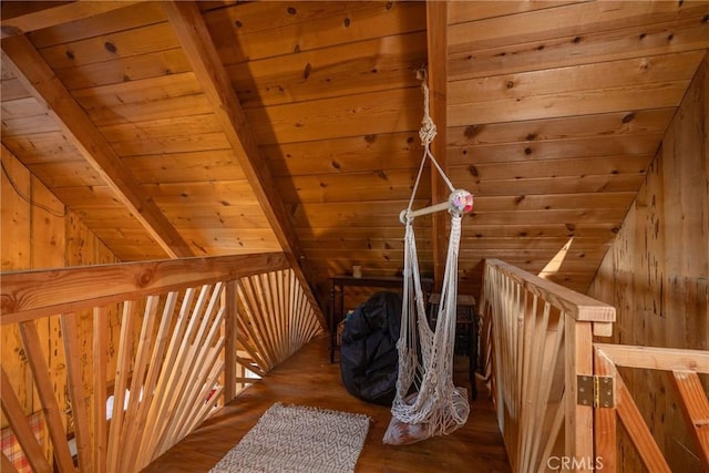 bonus room with wood ceiling, vaulted ceiling with beams, hardwood / wood-style floors, and wood walls