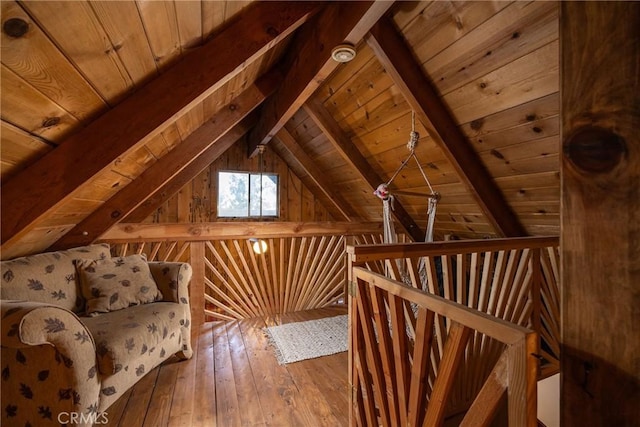 interior space featuring hardwood / wood-style floors, wood ceiling, wooden walls, and vaulted ceiling with beams