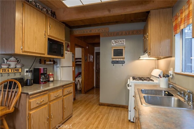 kitchen with beam ceiling, sink, white appliances, and light hardwood / wood-style floors