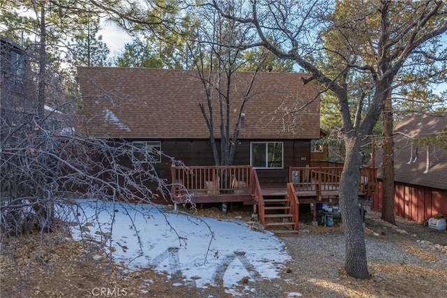 back of property with a wooden deck