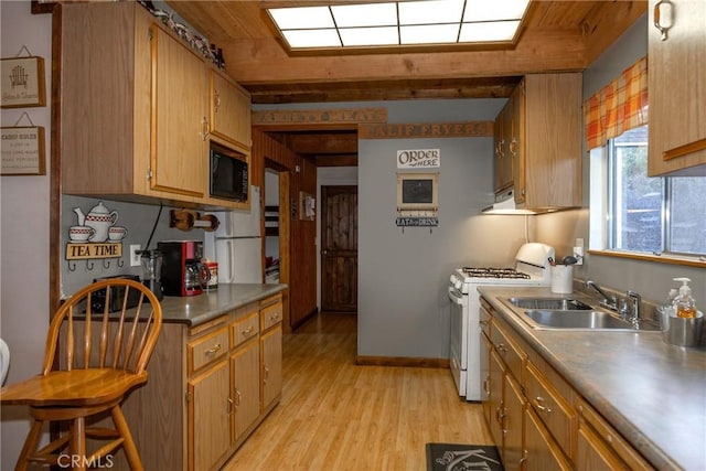 kitchen featuring sink, light hardwood / wood-style flooring, white gas range oven, black microwave, and wooden ceiling