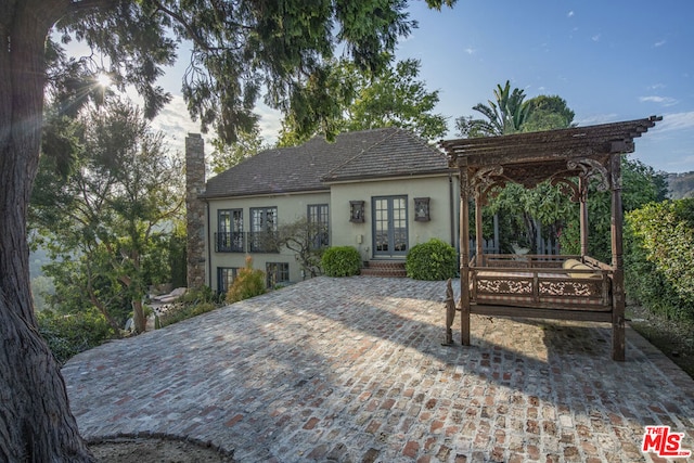 rear view of house featuring french doors