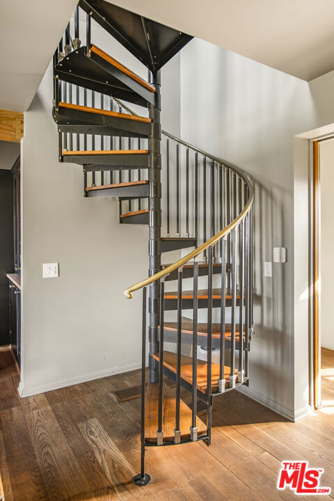 stairs with hardwood / wood-style floors