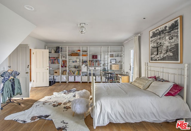 bedroom with hardwood / wood-style flooring