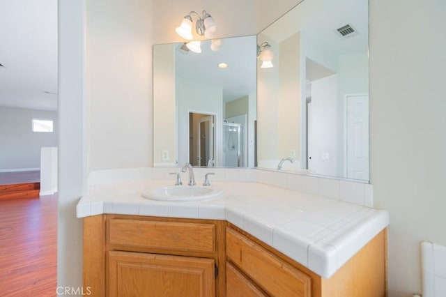 bathroom featuring vanity and wood-type flooring