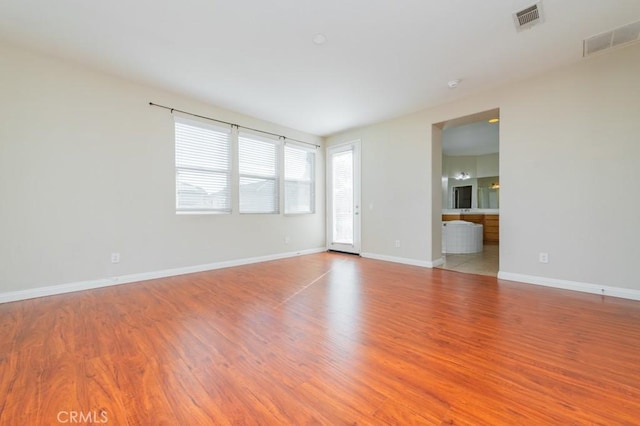 spare room with light hardwood / wood-style floors