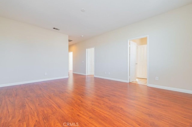 unfurnished room with wood-type flooring