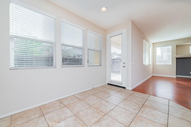 doorway with light tile patterned floors