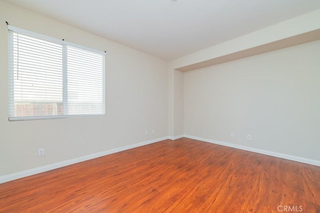 unfurnished room featuring hardwood / wood-style flooring