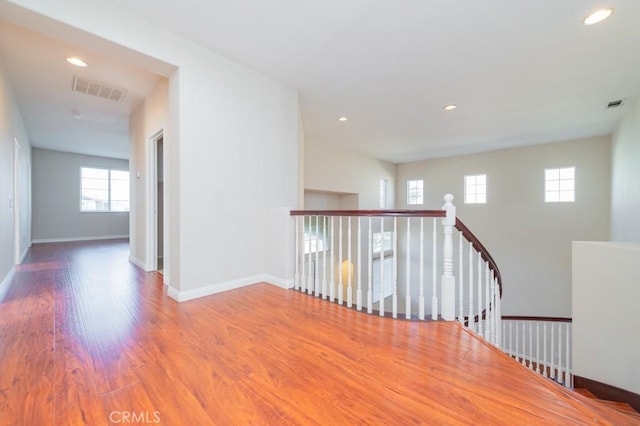 corridor with hardwood / wood-style floors