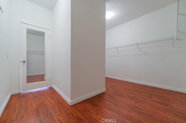 walk in closet with hardwood / wood-style flooring