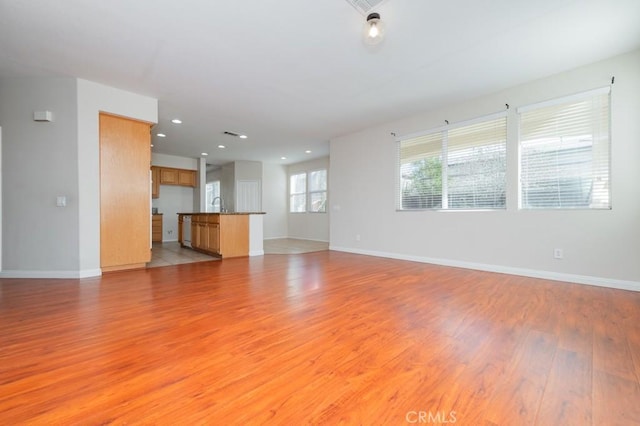 unfurnished living room with light hardwood / wood-style floors