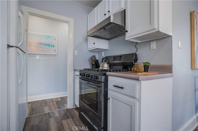 kitchen with white fridge, dark hardwood / wood-style floors, white cabinets, and gas range oven