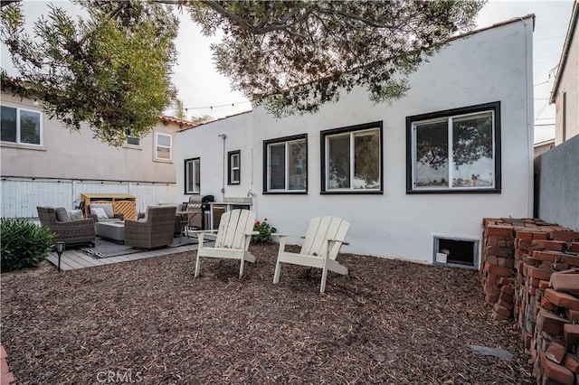 rear view of property featuring outdoor lounge area and a patio