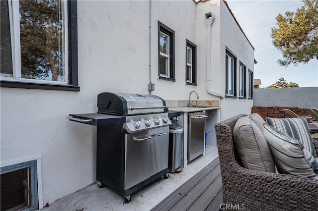 view of patio with grilling area, exterior kitchen, and sink