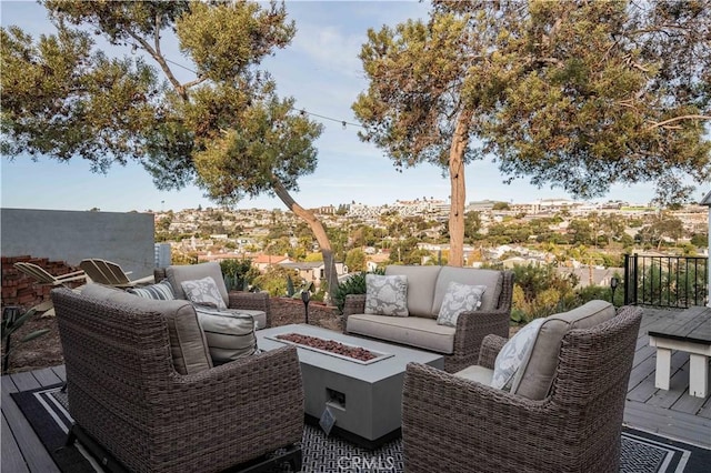 wooden deck with an outdoor living space with a fire pit