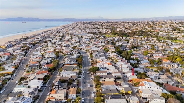 aerial view with a water and mountain view and a beach view