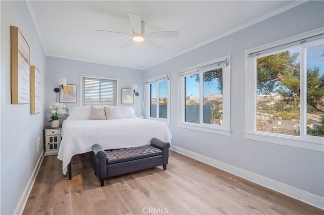 bedroom featuring ornamental molding, ceiling fan, and light hardwood / wood-style floors