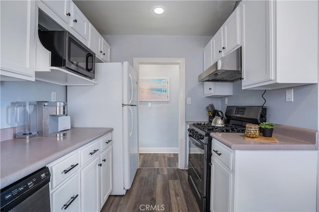 kitchen featuring stainless steel appliances, white cabinetry, and dark wood-type flooring