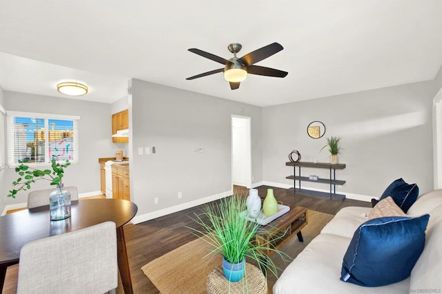 living room featuring dark hardwood / wood-style floors and ceiling fan