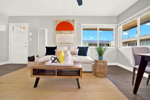 living room featuring hardwood / wood-style floors and ceiling fan