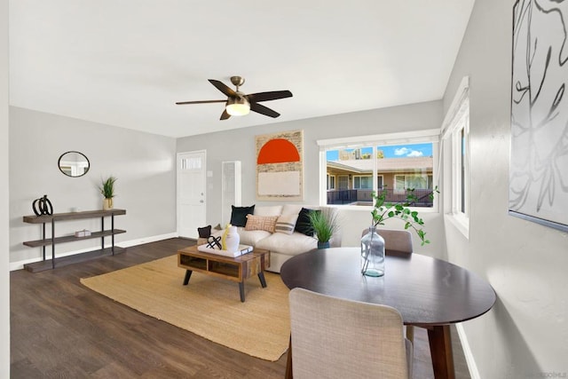 living room featuring dark hardwood / wood-style floors and ceiling fan