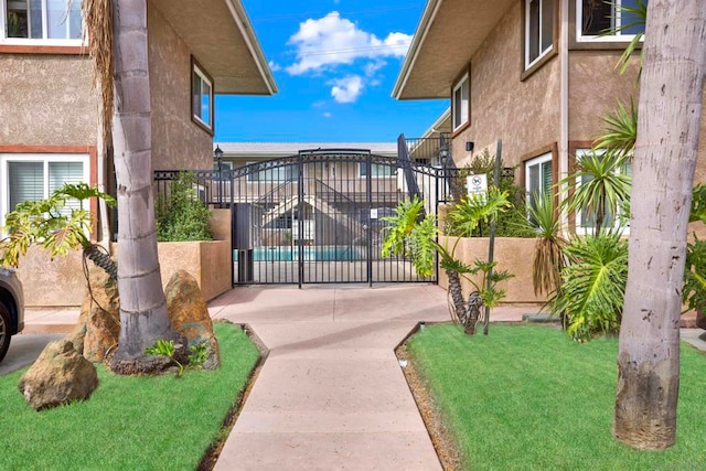 view of gate featuring a yard