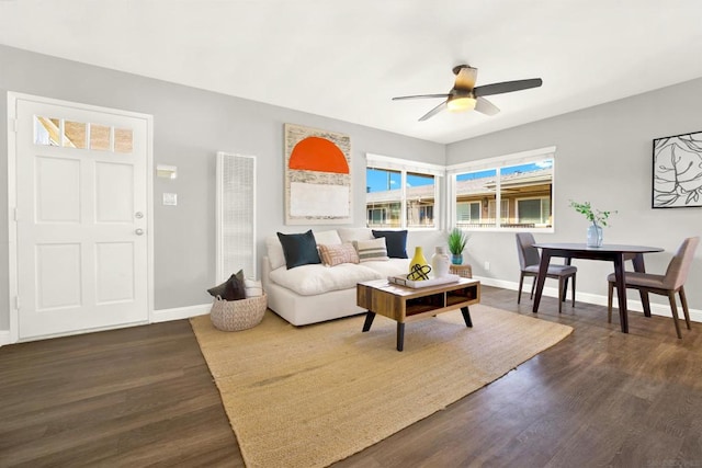 living room featuring dark hardwood / wood-style floors and ceiling fan