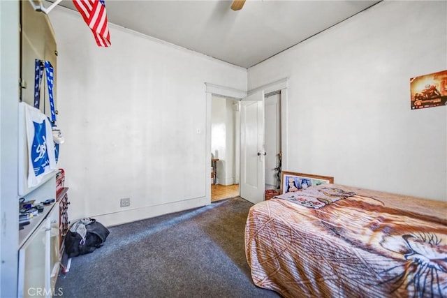 bedroom featuring ceiling fan and dark colored carpet