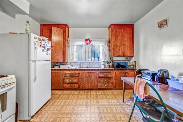 kitchen with white appliances and tile countertops