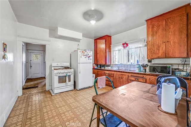 kitchen featuring white appliances and tile counters