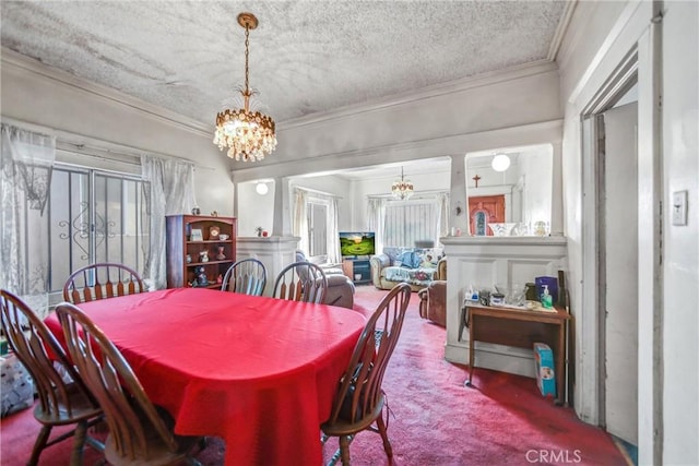 dining room with carpet, an inviting chandelier, a textured ceiling, and crown molding