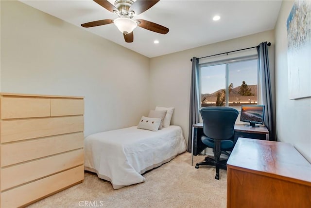 bedroom featuring light colored carpet and ceiling fan