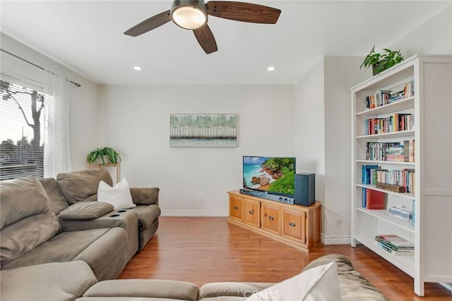 living room featuring light wood-type flooring and ceiling fan