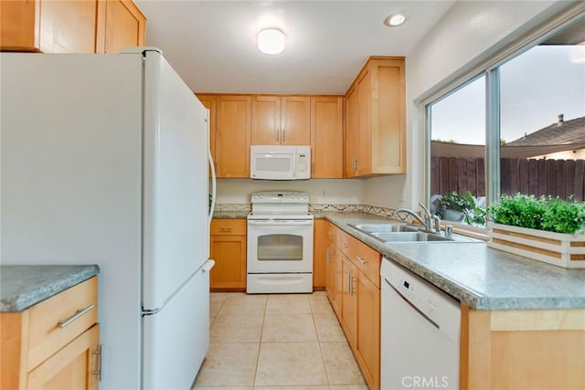 kitchen featuring sink, white appliances, light brown cabinets, and light tile patterned flooring