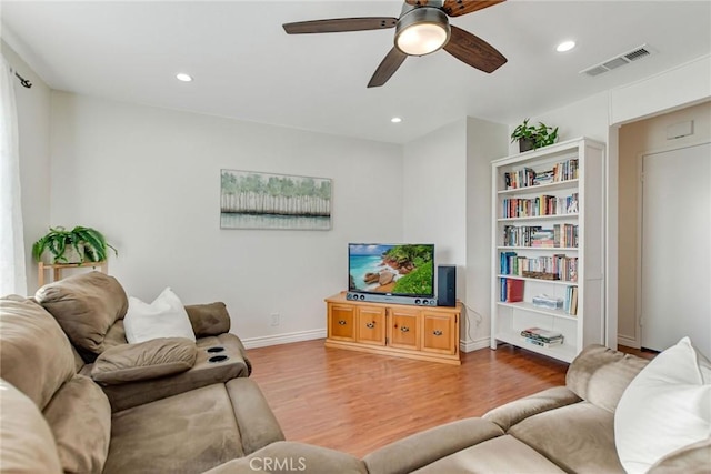 living room with ceiling fan and wood-type flooring