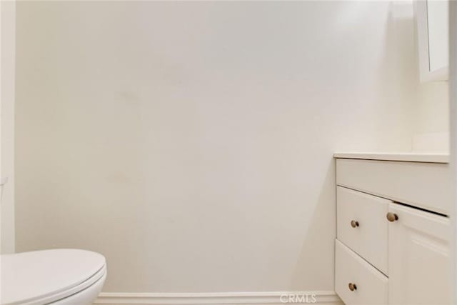 bathroom featuring toilet and vanity