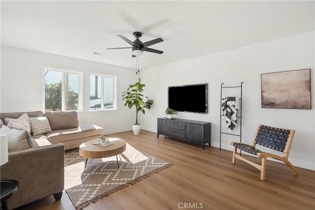 living room featuring ceiling fan and wood-type flooring