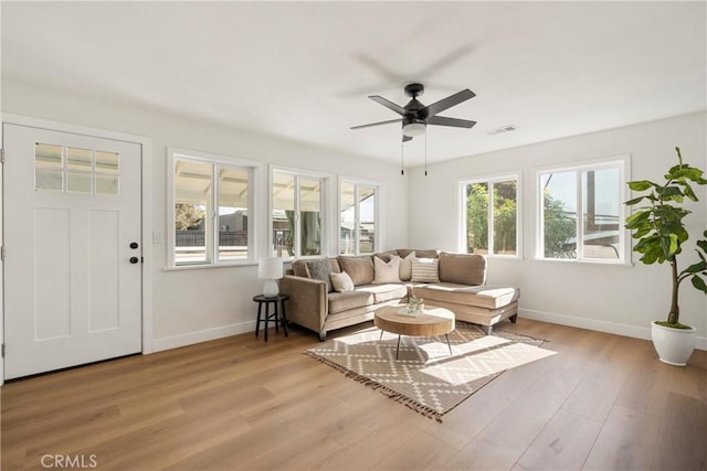 living room with light hardwood / wood-style floors and ceiling fan