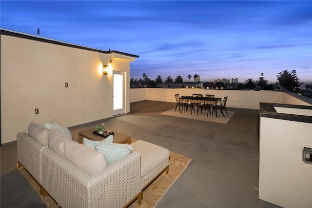 patio terrace at dusk featuring an outdoor living space